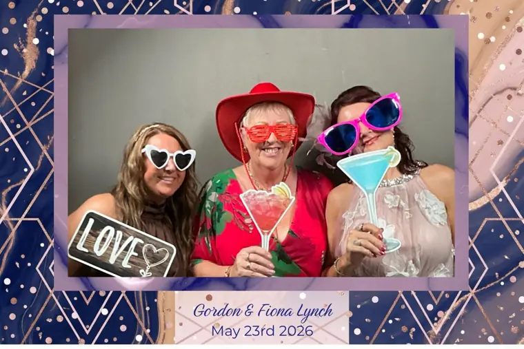 Navy geometric rose-gold bordered wedding photo booth print of three guests with cocktail-glass and Love props at Gordon & Fiona Lynch's wedding, 23rd May 2026