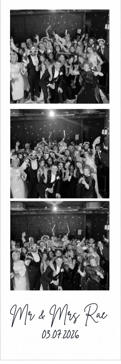 Three-frame black-and-white photo booth print strip of a wedding party crowd, signed Mr & Mrs Rae 03.07.2026