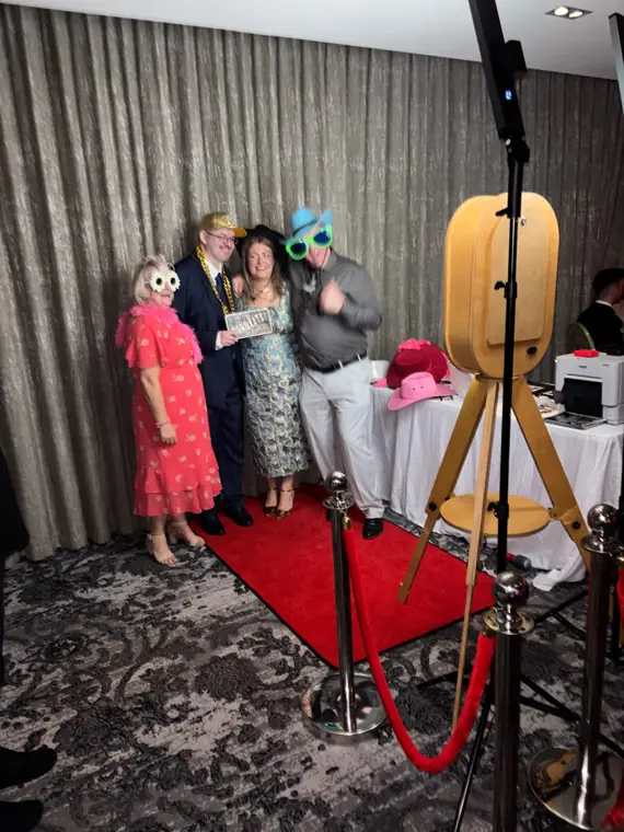 Wedding guests posing with Magic Mirror booth on red carpet
