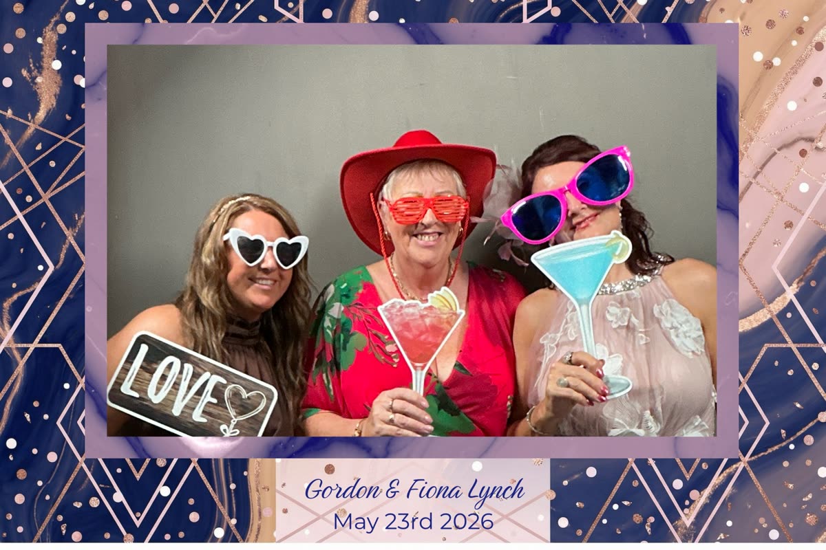Navy geometric rose-gold bordered wedding photo booth print of three guests with cocktail-glass and Love props at Gordon & Fiona Lynch's wedding, 23rd May 2026